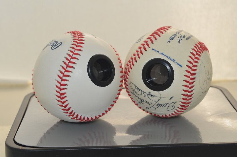 Two Showball baseballs with eyepieces, one carrying an Allan H. Selig commissioner signature