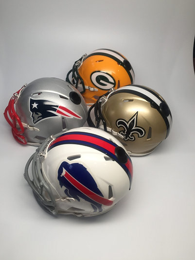 Four Showball mini speed helmets in Patriots, Packers, Saints and Bills finishes